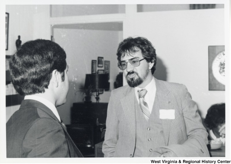 Congressman Nick Rahall Ii speaking with a unidentified man.